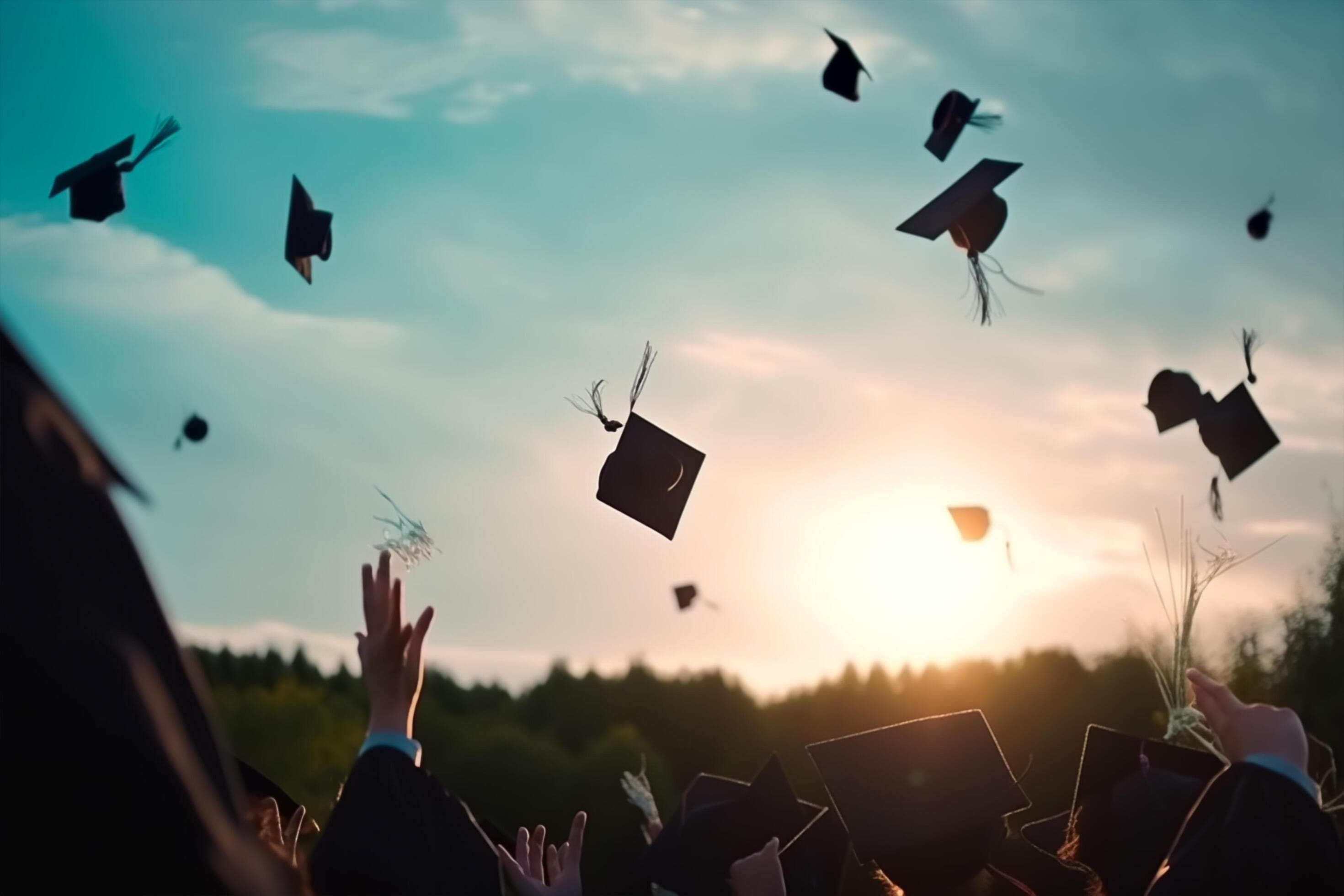 Graduates throwing caps with city skyline in background